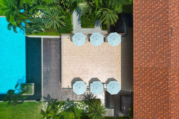 Aerial view of resort terrace with Alizé commercial patio umbrellas showing off-season product development and global hospitality reach