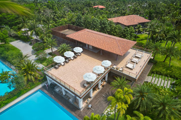 Commercial outdoor patio with Alizé umbrellas at a resort pool showing customized shade system layout